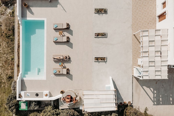 An aerial view of a pool area with lounge chairs and a small pool. - Villa of Roses - Private villa with pool (Naxos)