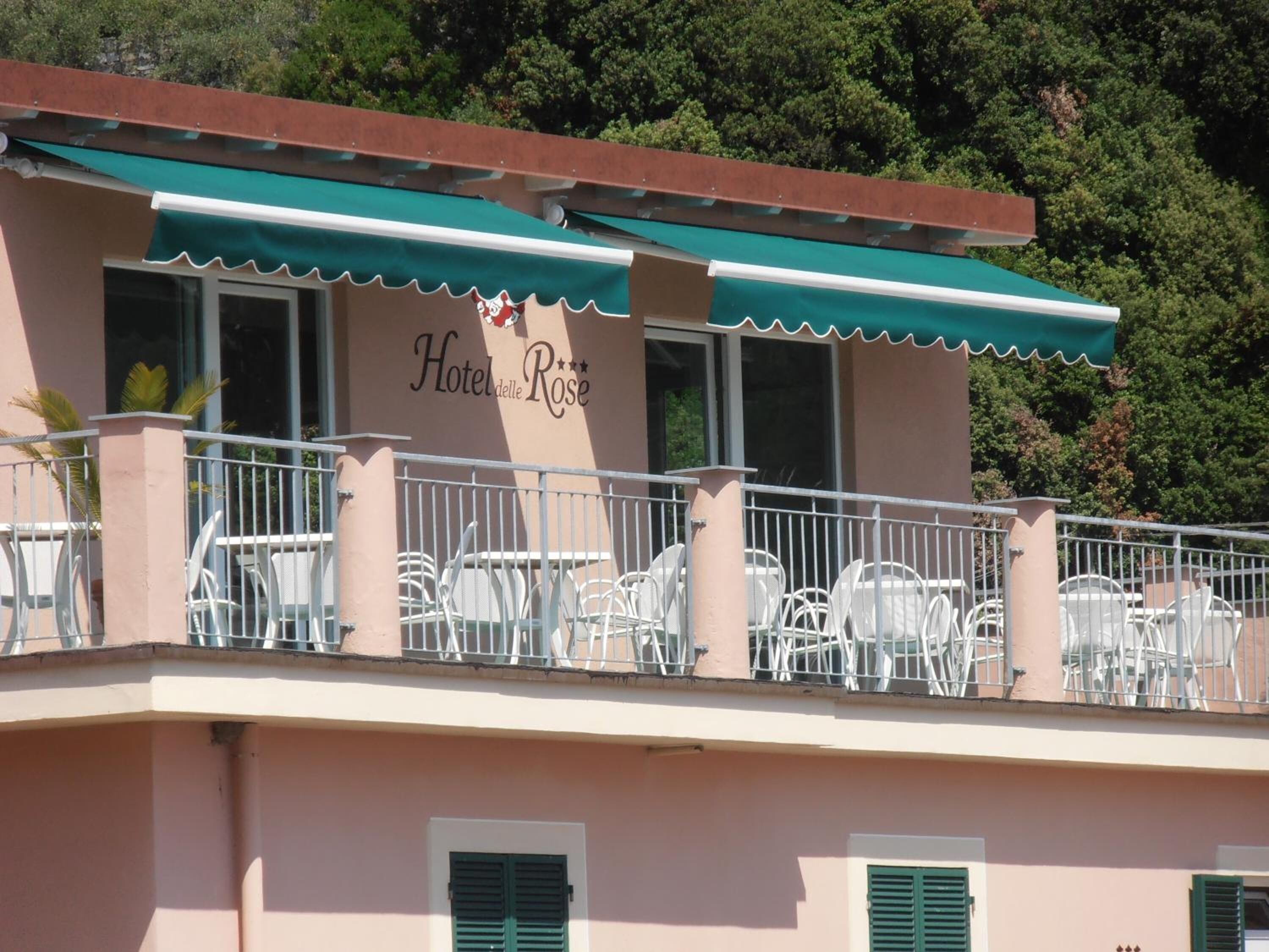 A hotel named "Hotel delle Rose" with outdoor seating and a balcony.