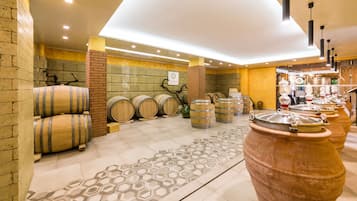 A modern interior with wooden barrels, a patterned rug, and a brick wall.