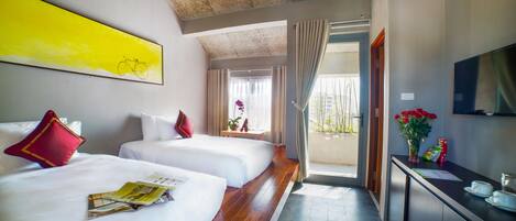 A hotel room with two beds, a large window, a balcony, and a television on the wall.