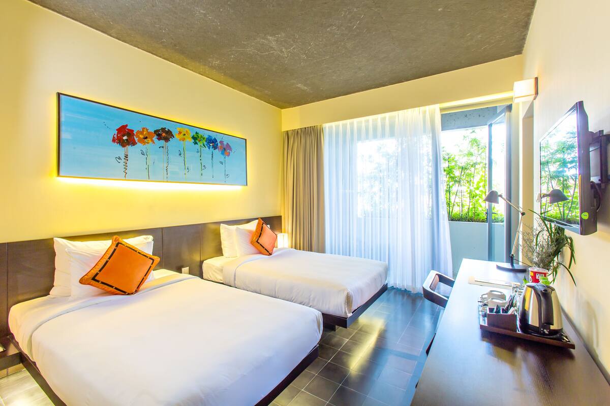 A hotel room with two beds, a large window with curtains, a flat-screen TV, and a painting on the wall.