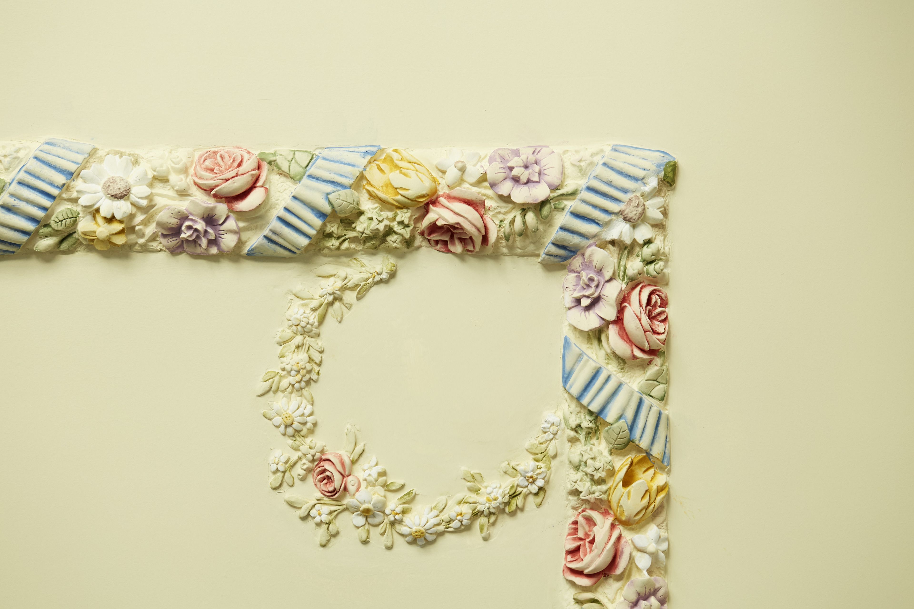 A decorative floral arrangement forming the letter 'L' on a plain background.