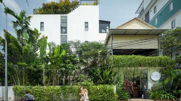Un edificio moderno con fachada blanca, techo verde y un letrero que dice 'Cederz SIEM REAP'.