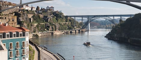 Une rivière avec un pont, un bateau et des bâtiments le long de la rive.