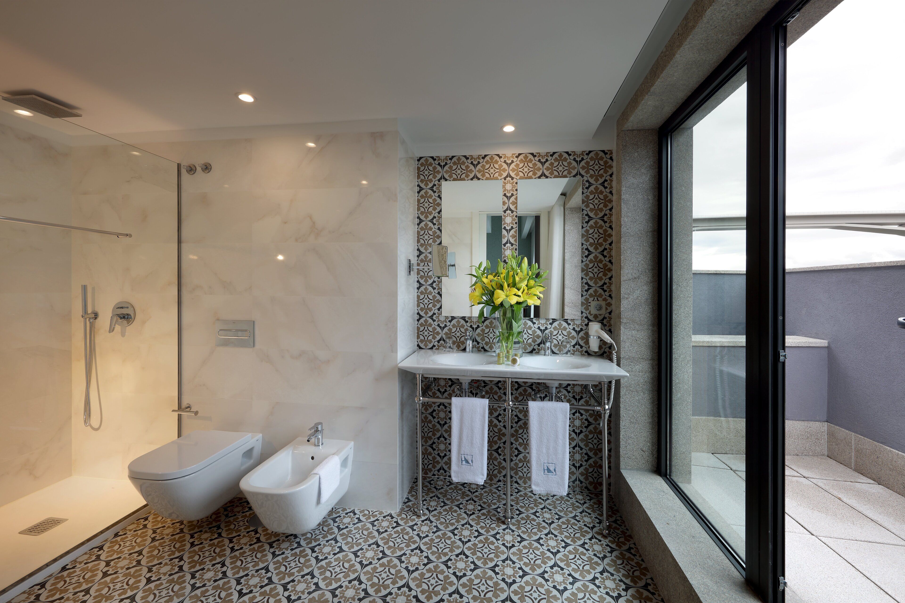 junior suite | bathroom | shower, rainfall showerhead, eco-friendly toiletries, hair dryer