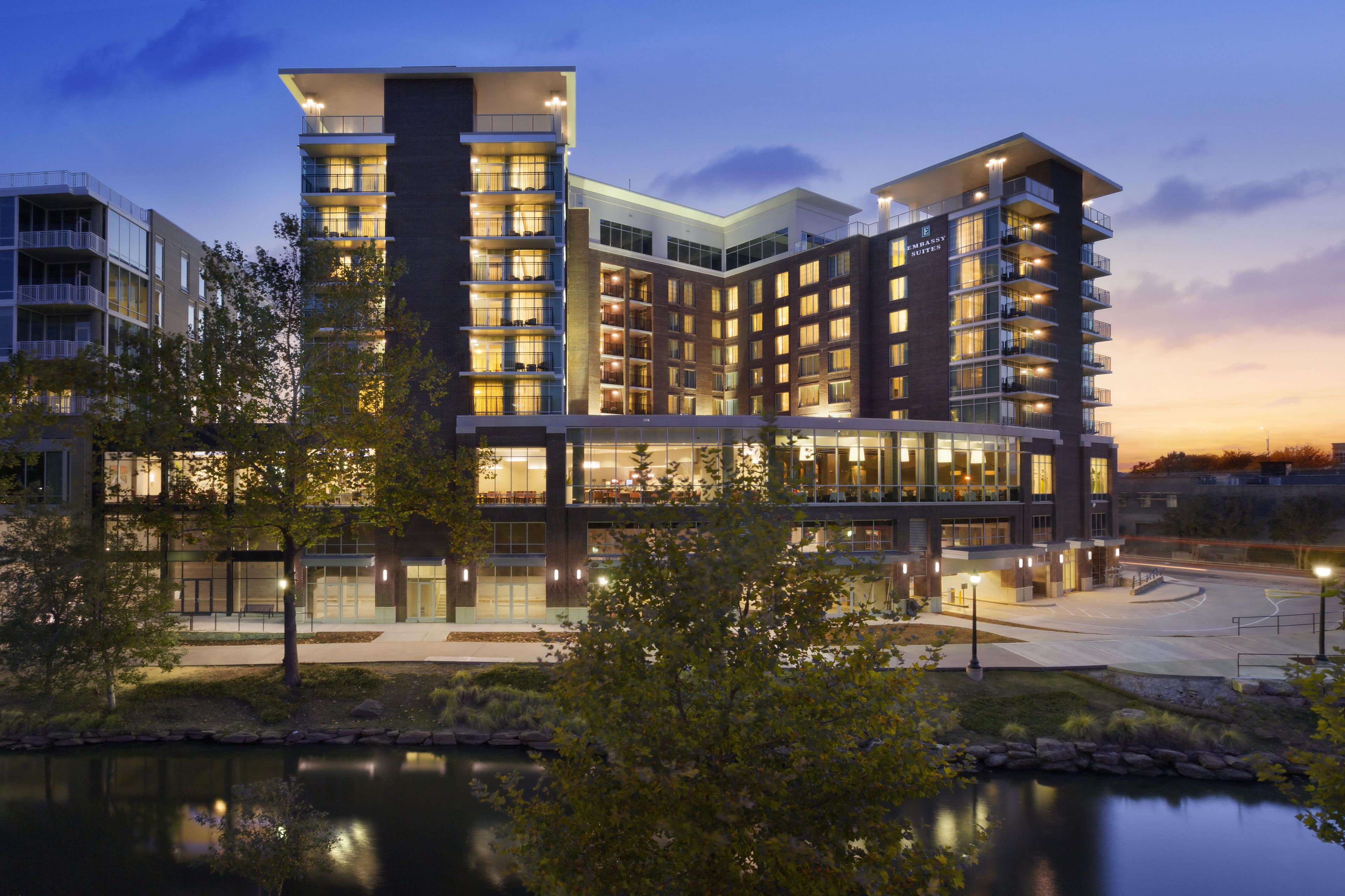 A multi-story hotel with a modern architectural design, featuring balconies and large windows.