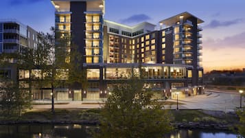 A multi-story hotel with a modern architectural design, featuring balconies and large windows.