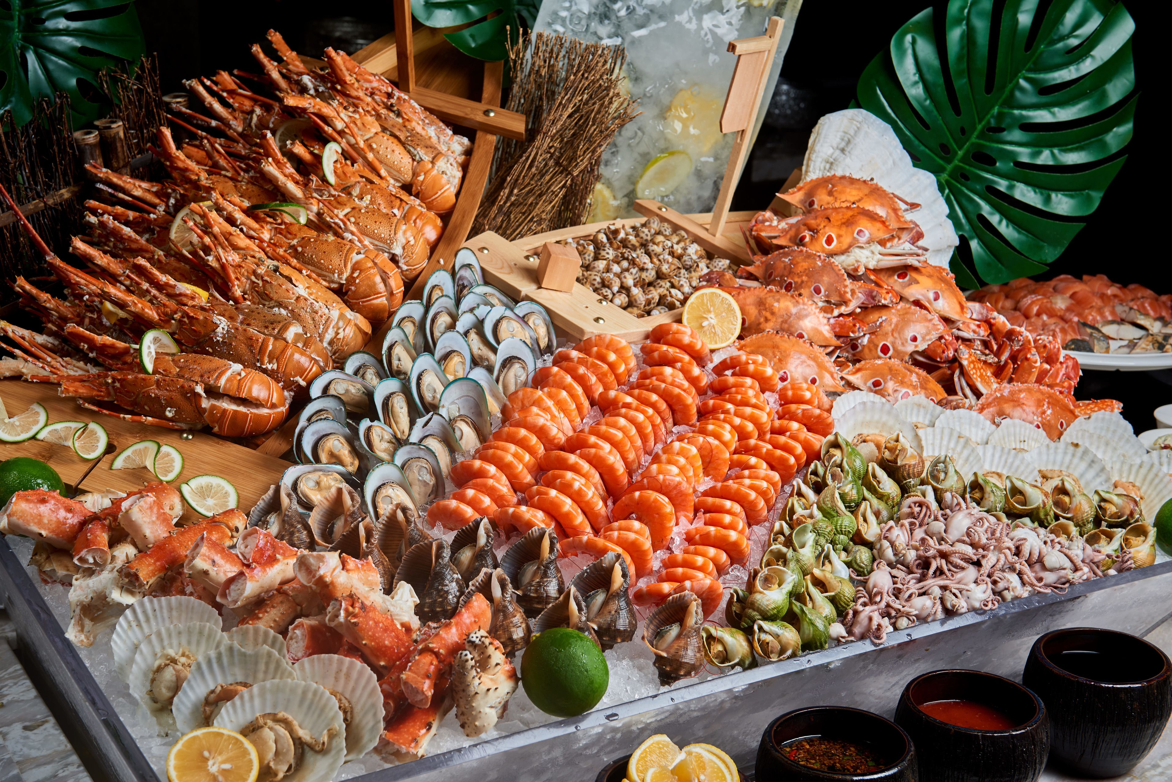 A seafood display with various types of shellfish and lobsters.