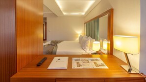 A hotel room with a wooden desk, a remote control, a notebook, and a brochure. - Lamec Hotel Business (Gebze)