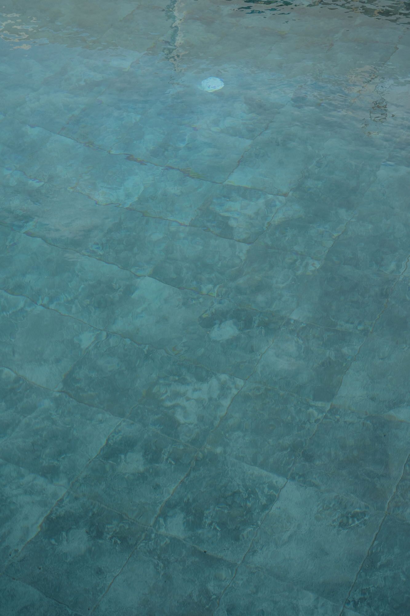 A clear view of a tiled floor with a pattern of square tiles.