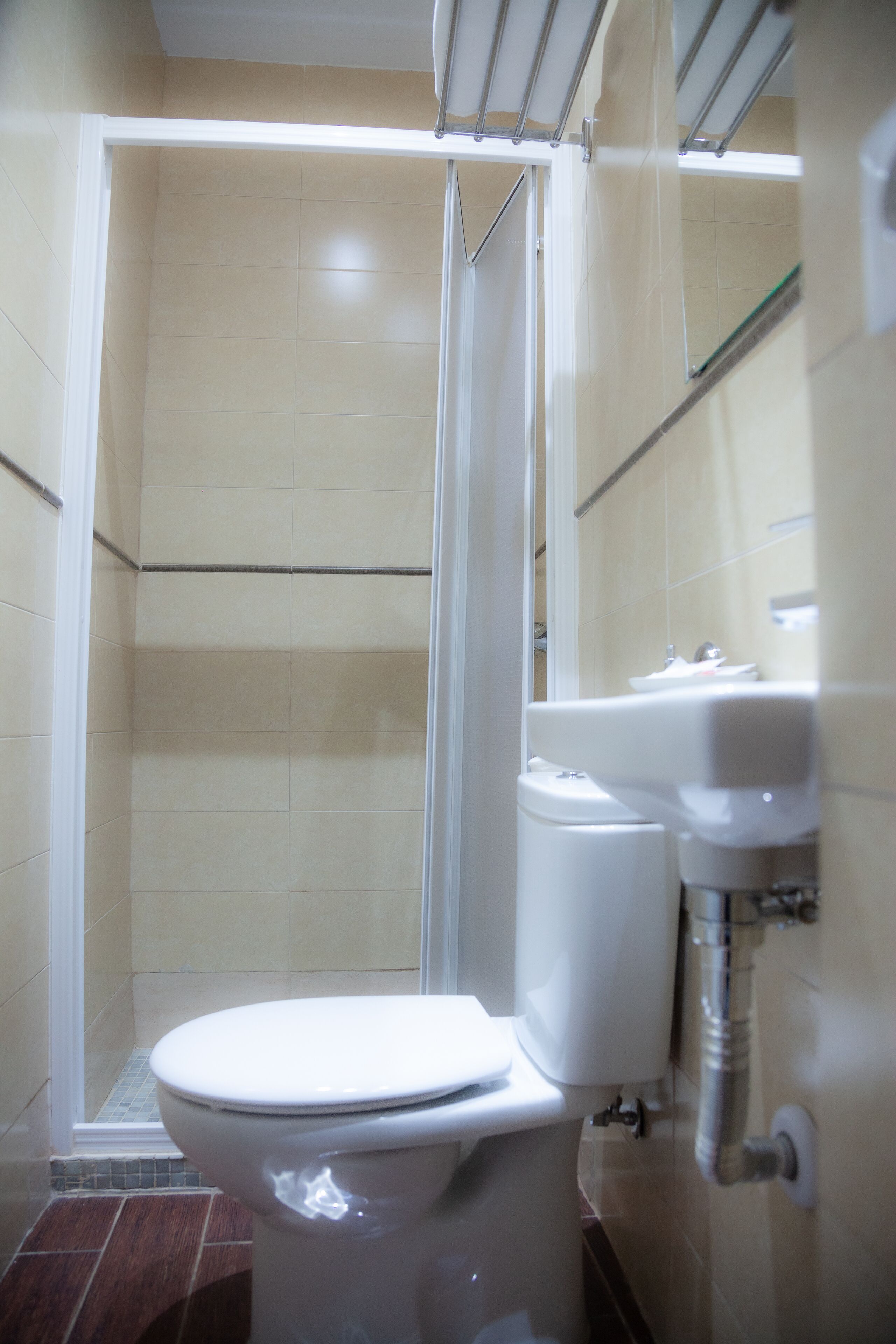 A bathroom with a shower, toilet, and sink.