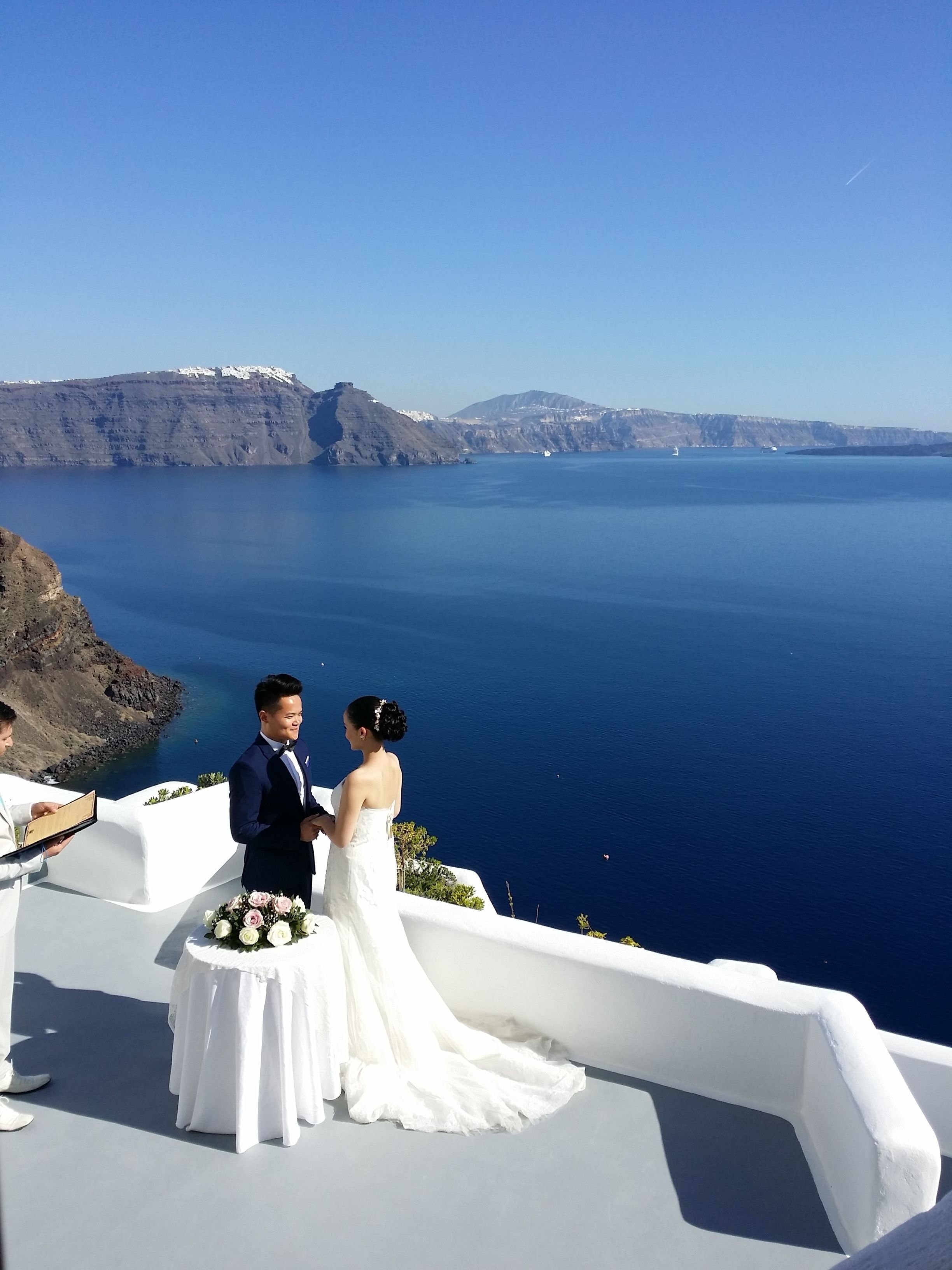A wedding ceremony with a view of the sea and mountains.