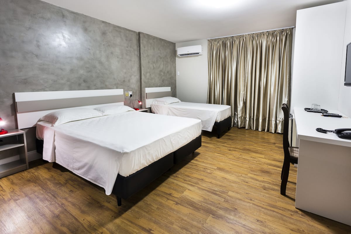 Standard Triple Room | Minibar, in-room safe, desk, blackout drapes