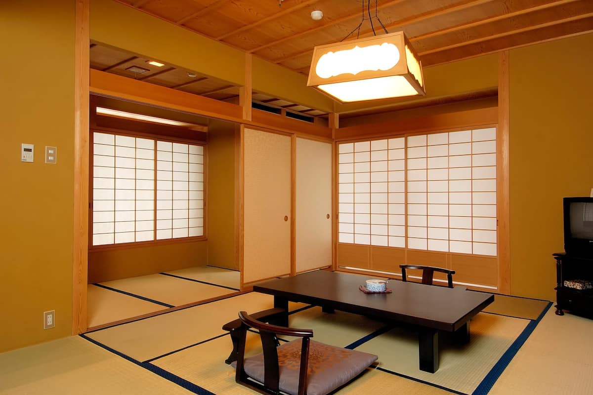 Een traditionele Japanse kamer met tatami vloeren, een lage tafel en schuifdeuren.