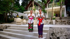 Two individuals standing on stone steps in front of a modern house with a balcony. - Villa Greenday (Cepaka)