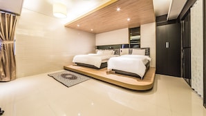 Un dormitorio moderno con dos camas, techo de madera y un espejo grande.