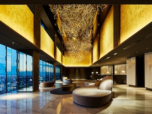 A spacious lobby with a high ceiling, large windows offering a city view, and modern seating arrangements. - Mitsui Garden Hotel Nagoya Premier (Nagoya)