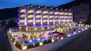 A multi-story hotel with outdoor seating and a swimming pool. - Piccolo Dream Hotel - All Inclusive - Adults Only (Marmaris)