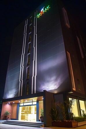 A modern hotel with a prominent sign at the top, a well-lit entrance, and a clean facade. - Holly Hotel Myanmar (Yangon)