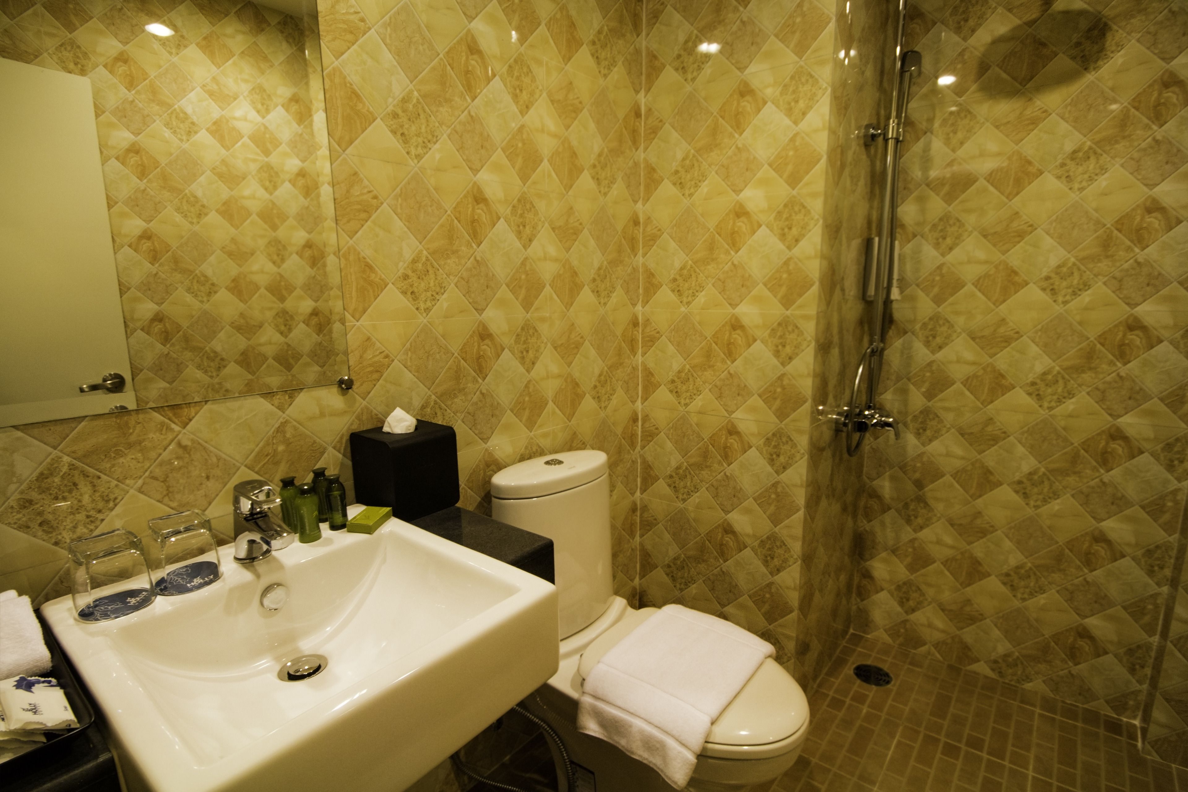 A bathroom with a sink, toilet, and shower.