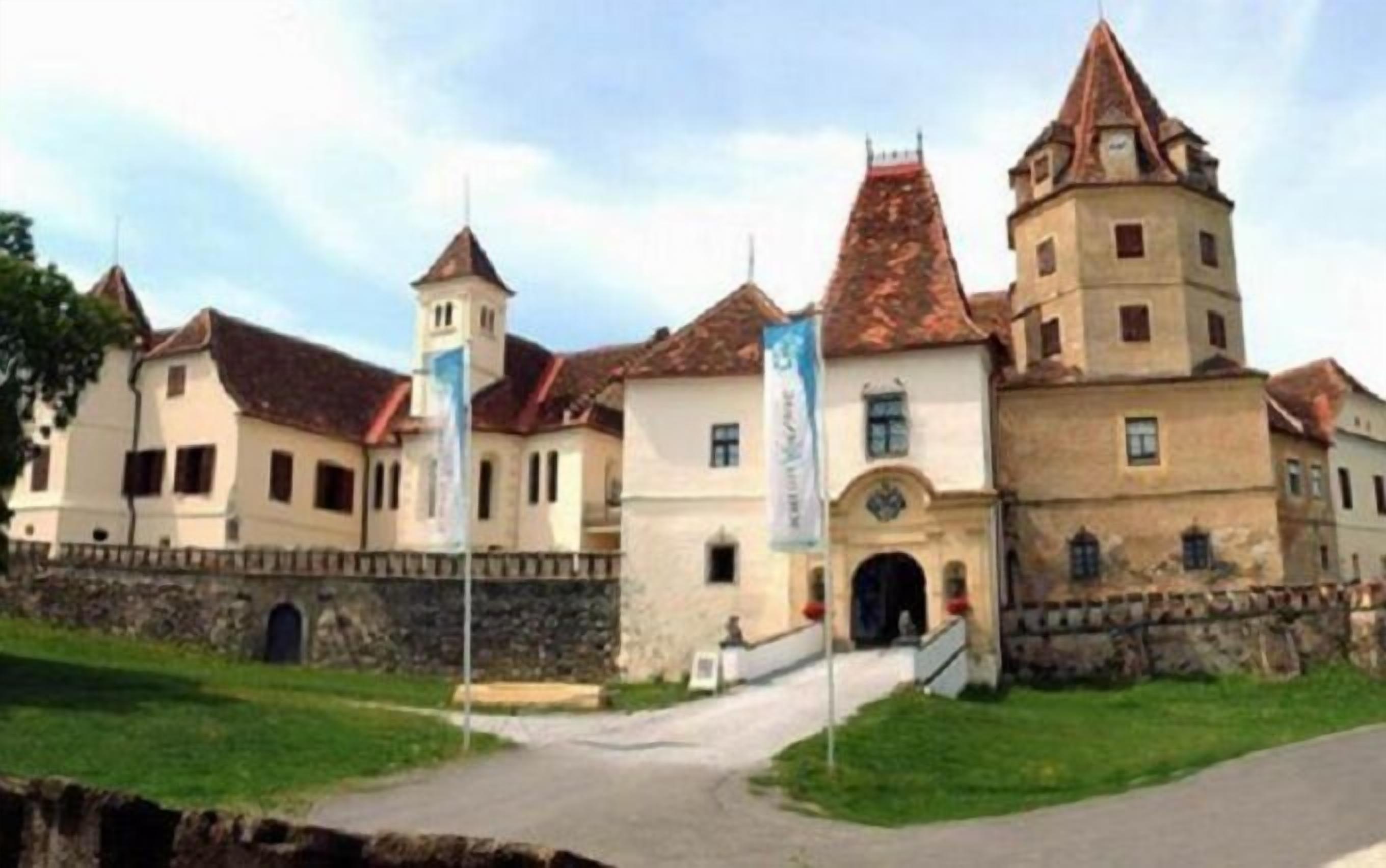 A historic building with multiple towers and a central entrance.