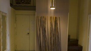 A hallway with a door, a staircase, and a bamboo installation. - Dimora dei Giganti (Naples)