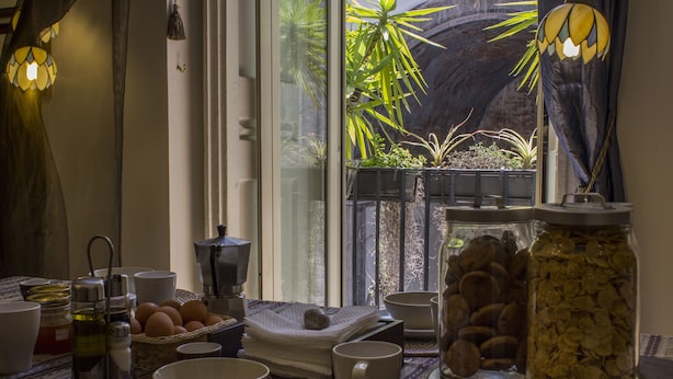 A breakfast setup with a view of a garden through a window. - Diletto a Napoli B&B (Naples)