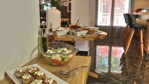A dining table with various food items and a glass bowl of salad. - Elia Kentron- Adults Only (Chania)