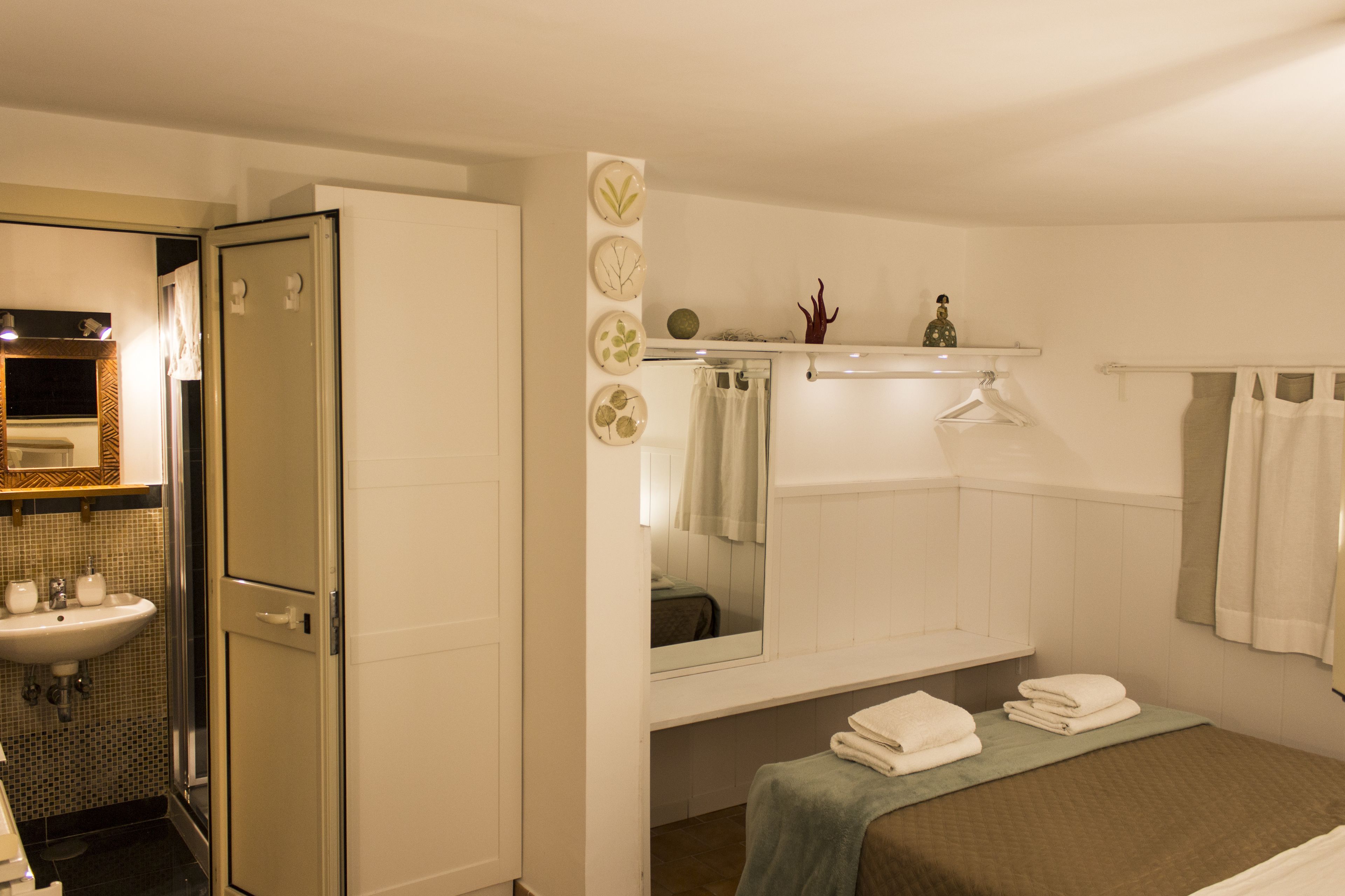 Une salle de bain équipée d’un lavabo, d’un miroir et d’un porte-serviettes.