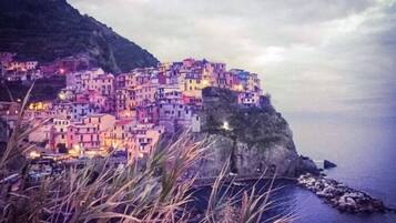 A coastal village with colorful buildings perched on a cliff.