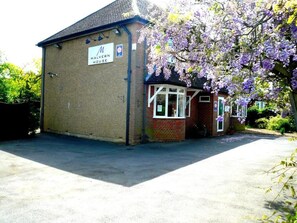A building with a sign reading 'MALVERN HOUSE' and a small attached structure with windows. - Malvern House (High Wycombe)