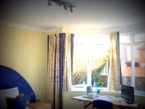 A room with a desk, chair, and a window with curtains. - Malvern House (High Wycombe)