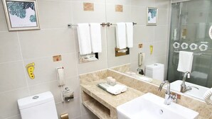 A modern bathroom with a large mirror, two sinks, a toilet, and a shower. - Media Center Hotel - Beijing (BEIJING)