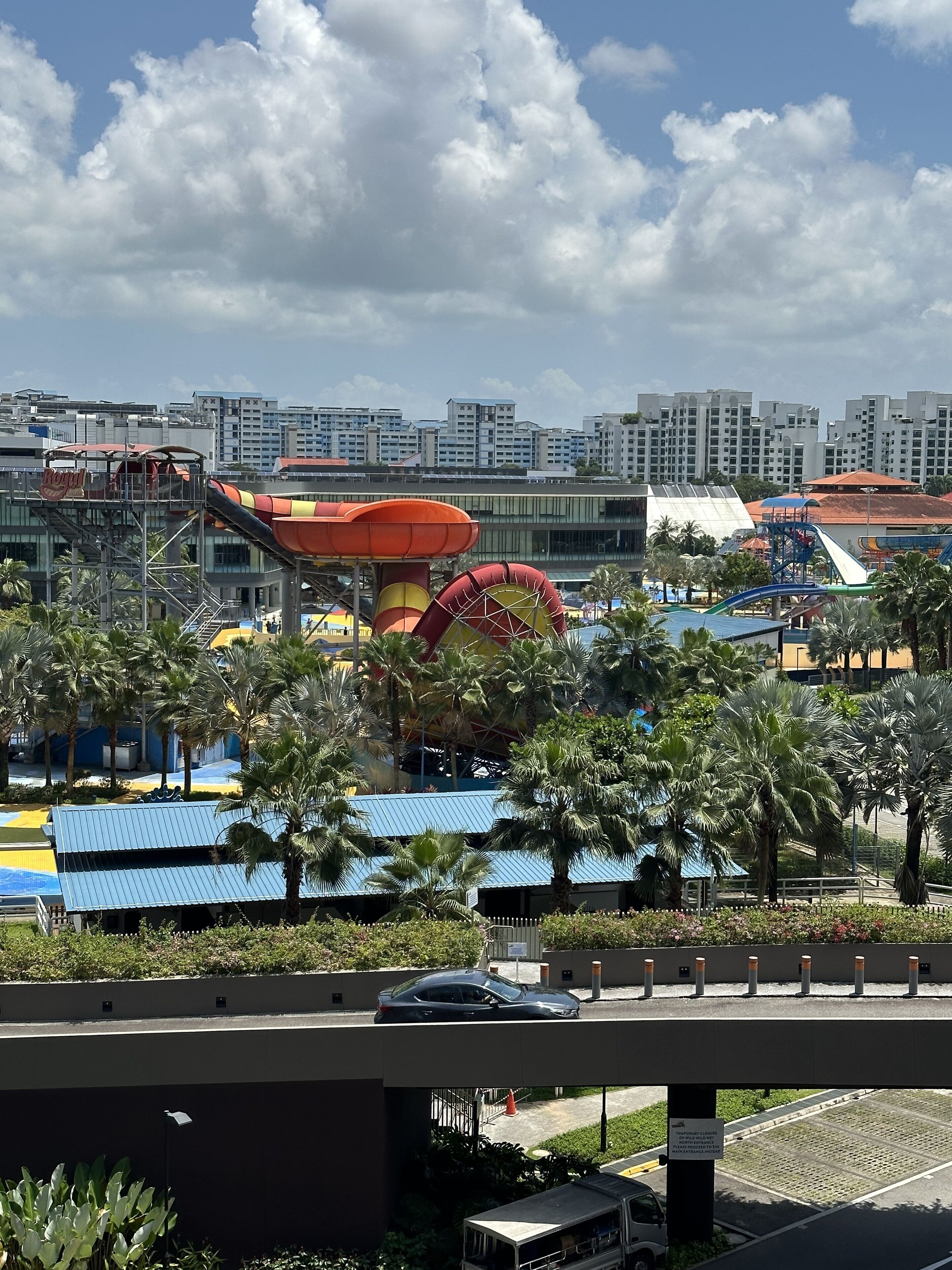 A water park with various water slides and a Ferris wheel.
