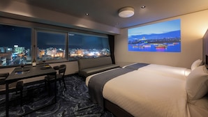 A hotel room with a large window, a bed, a desk, and a chair. - Niigata Grand Hotel (Niigata)