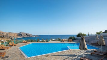 Seasonal outdoor pool, open 9:00 AM to 8:00 PM, pool umbrellas