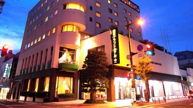 A multi-story hotel with a modern design, featuring a prominent entrance with a glass facade and a sign in a foreign language. - Yamagata Grand Hotel (Yamagata)