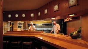 A restaurant interior with a wooden bar and seating area. - Yamagata Grand Hotel (Yamagata)