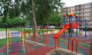 A playground with a slide, climbing structures, and a wooden ladder. - Iskar (Nessebar)