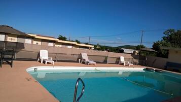 Relax by the pool with comfortable lounge chairs and a convenient ladder.
