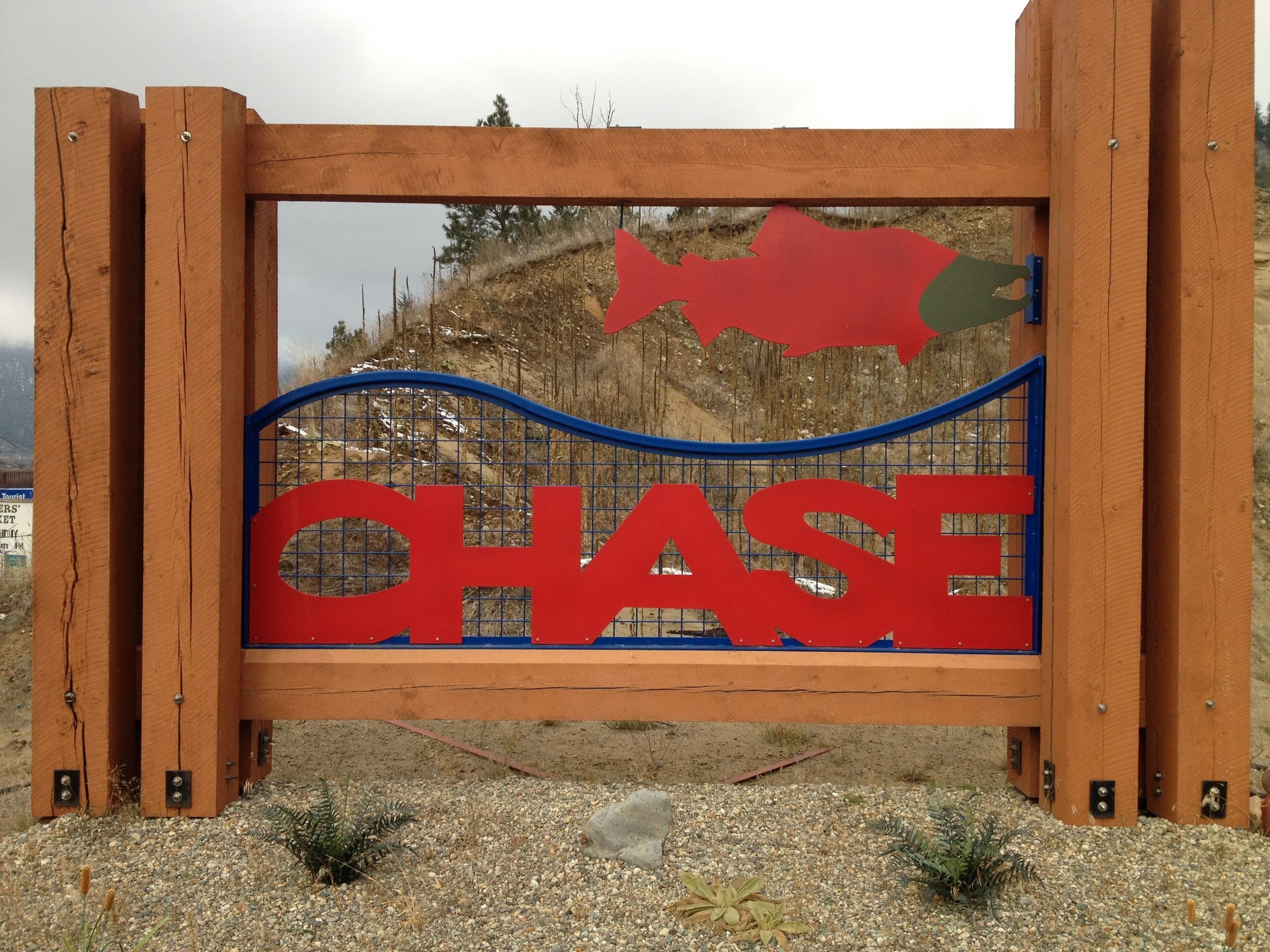 A wooden sign with the word "CHASE" and a fish silhouette.