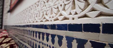 A close-up of a wall with intricate tile patterns and a blue and white color scheme.
