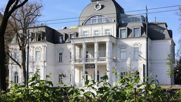 Experience the grandeur of this historic hotel, featuring a stunning balcony and ornate detailing.