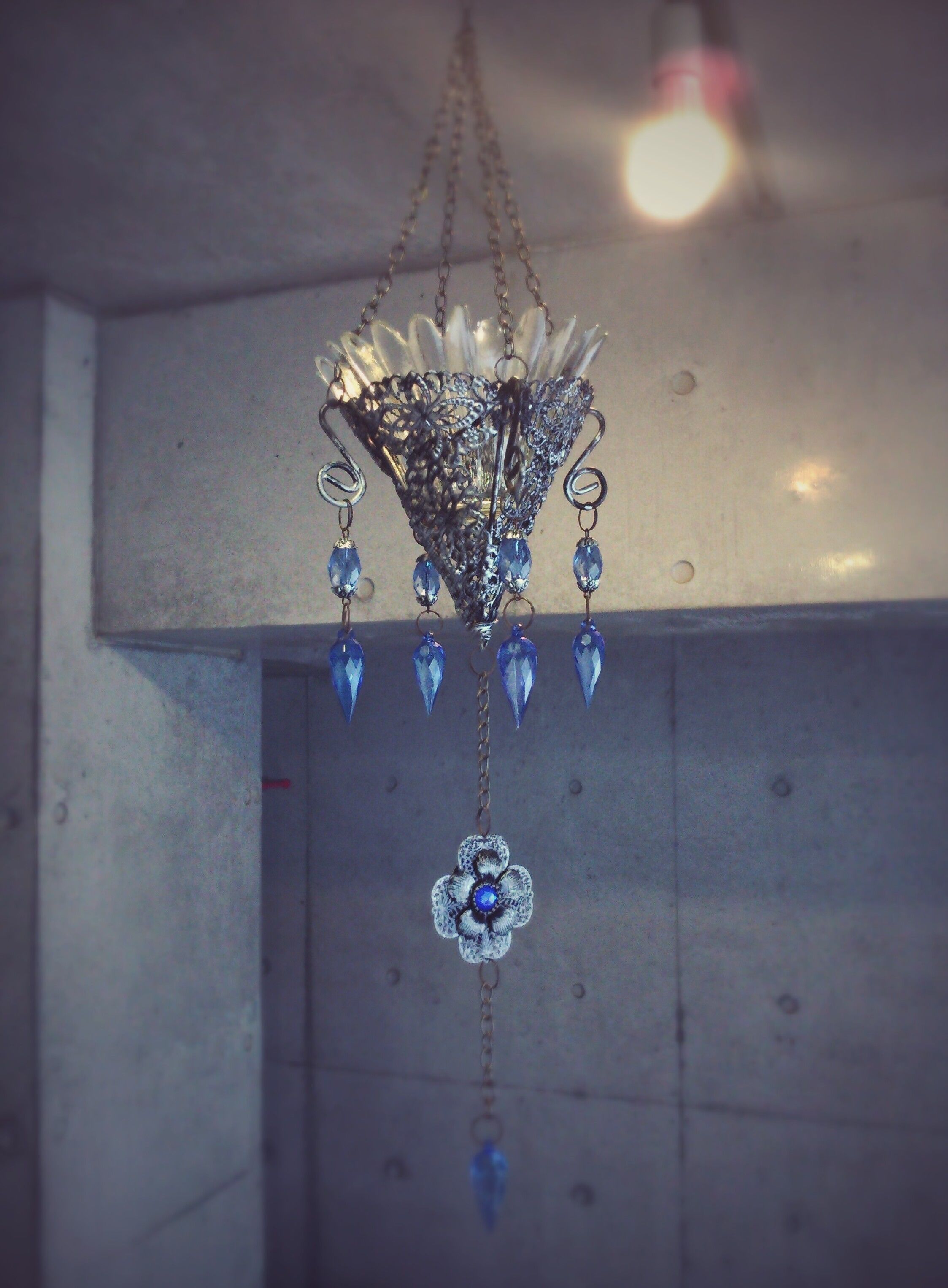 A chandelier with a floral design and blue crystal accents.