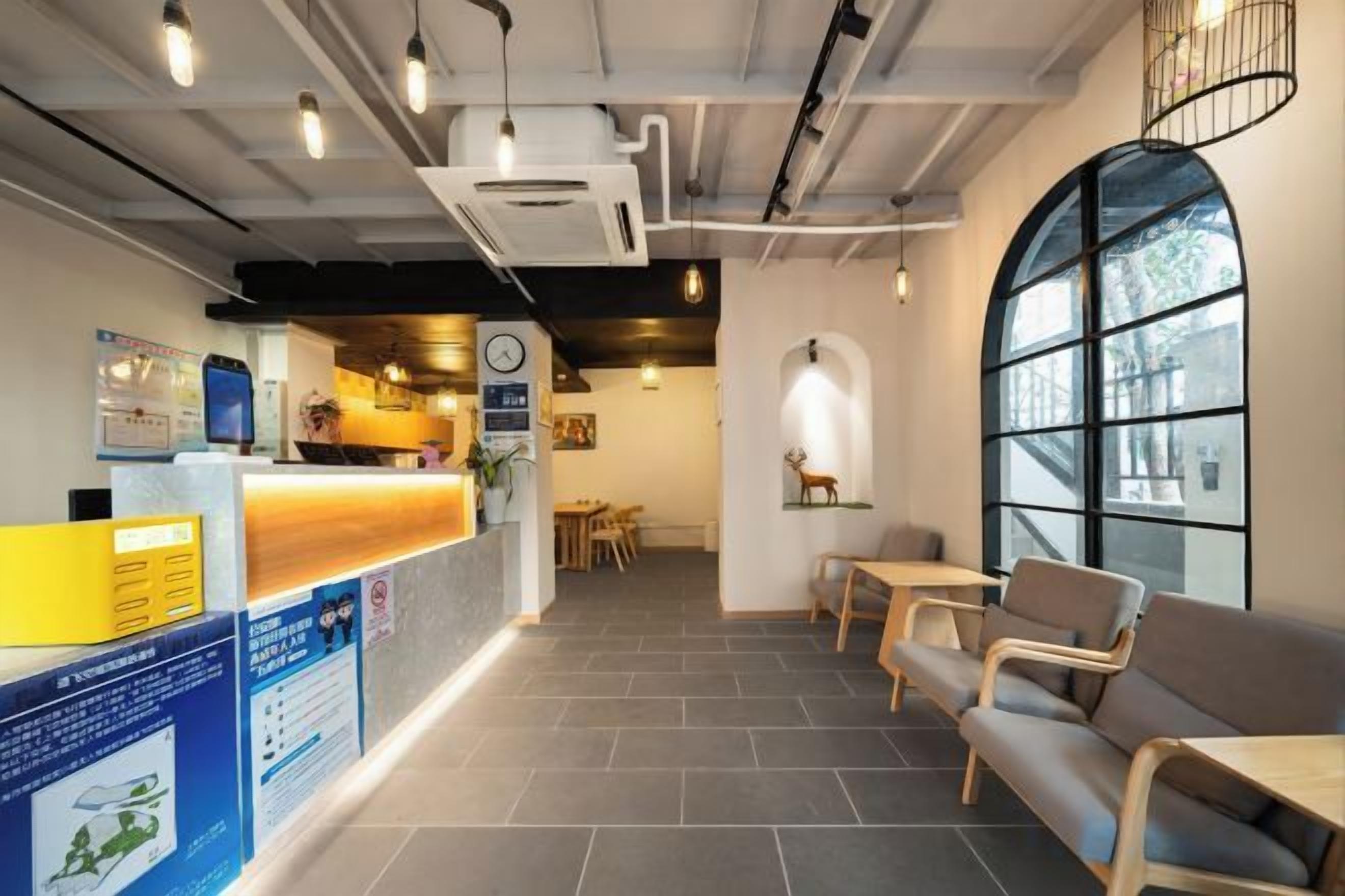 A reception area with a counter, seating, and a large window.