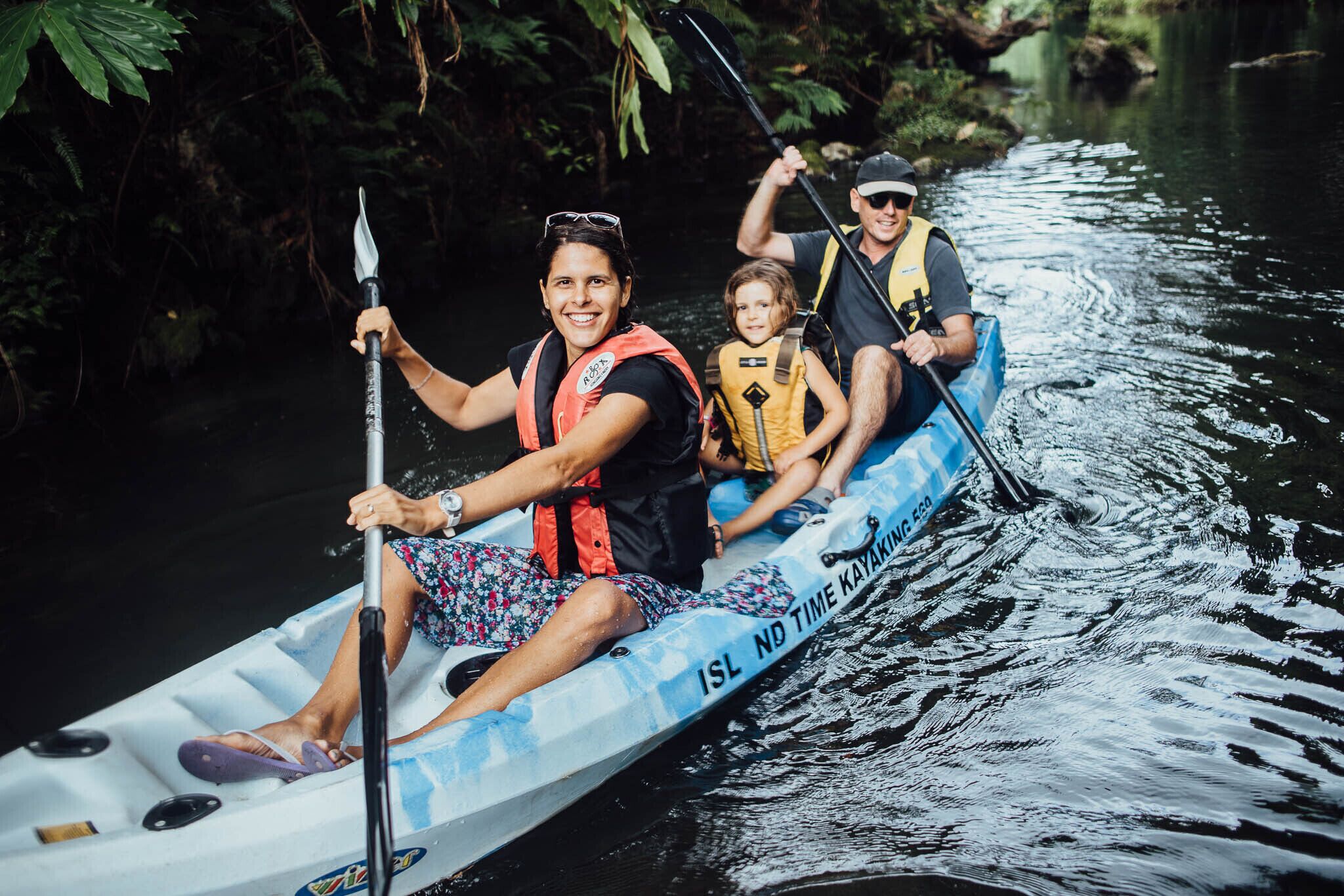 A group of people kayaking on a river.
