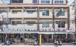 A restaurant named Smokin' Joe's BBQ Steak & Co. with outdoor seating and parked motorcycles. - Steak & Co. Boutique Hotel (Pattaya)