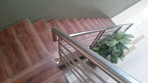 A staircase with wooden steps and metal railings. - Novatel Yogyakarta (Yogyakarta)