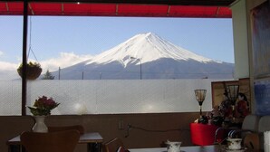 A dining area with a view of a snow-capped mountain.