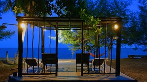 A gazebo with two chairs and a hammock, overlooking a beach with a view of the ocean. - 155 SalaCoco (Bang Saphan)